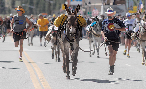 Pardner leads Kevin up Harrison Avenue at the start of the 62nd Anniversary International Pack Burro Race in Leadville as part of the Boom Days celebration Sunday.